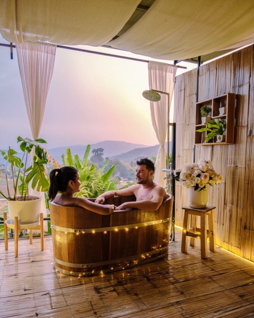 A couple in a bathtub in the evening during sunset